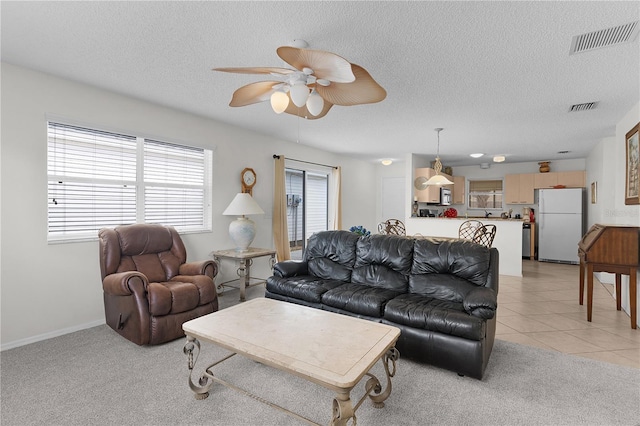 9321 SE 172nd Augusta Ln, The Villages, FL 32162 - living area with a ceiling fan, a textured ceiling, and light carpet
