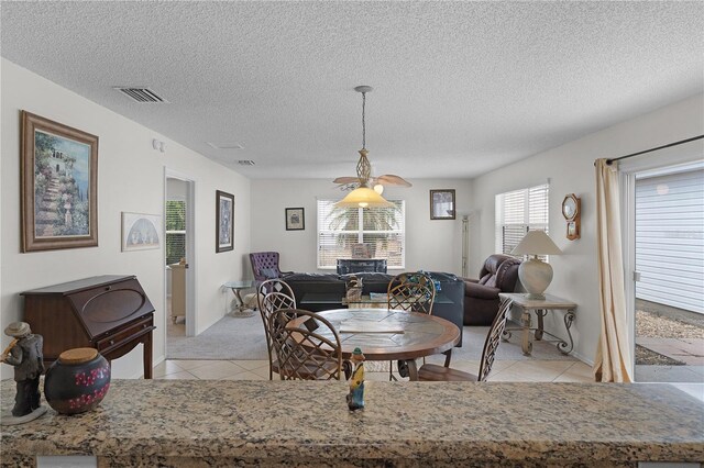 9321 SE 172nd Augusta Ln, The Villages, FL 32162 - living area with light tile patterned floors, a textured ceiling, and baseboards