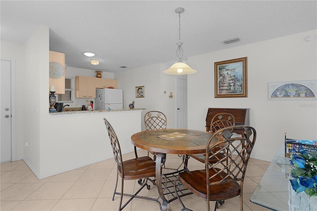 9321 SE 172nd Augusta Ln, The Villages, FL 32162 - dining space with a textured ceiling and light tile patterned flooring