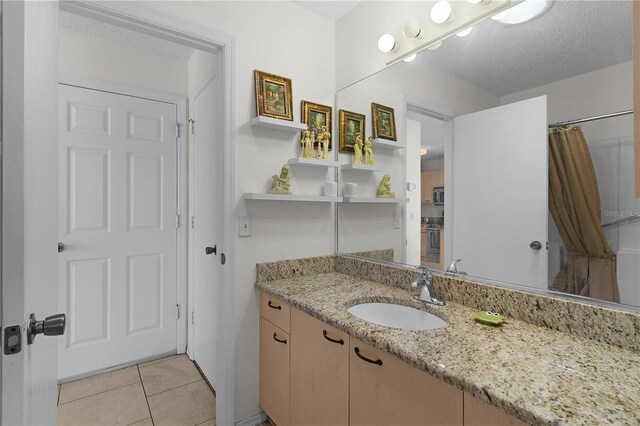 9321 SE 172nd Augusta Ln, The Villages, FL 32162 - full bath featuring vanity, tile patterned flooring, a shower with curtain, and a textured ceiling
