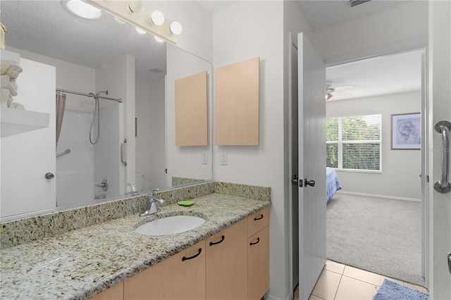 9321 SE 172nd Augusta Ln, The Villages, FL 32162 - bathroom with vanity, tile patterned floors, a textured ceiling, toilet, and ceiling fan