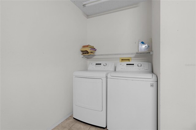 9321 SE 172nd Augusta Ln, The Villages, FL 32162 - laundry room with washing machine and clothes dryer and light tile patterned flooring
