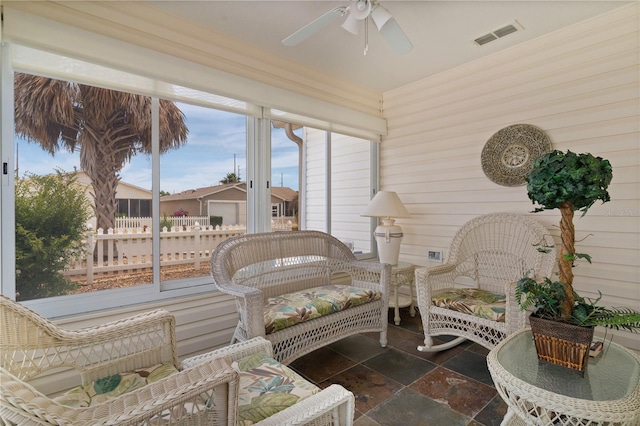 9321 SE 172nd Augusta Ln, The Villages, FL 32162 - sunroom with stone tile floors, ceiling fan, and wood walls