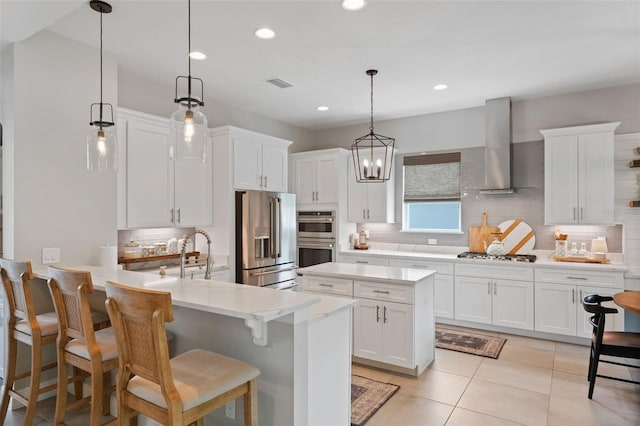 9512 Mid Summer Ln, Leesburg, FL 34788 - kitchen featuring appliances with stainless steel finishes, wall chimney range hood, backsplash, white cabinets, and recessed lighting