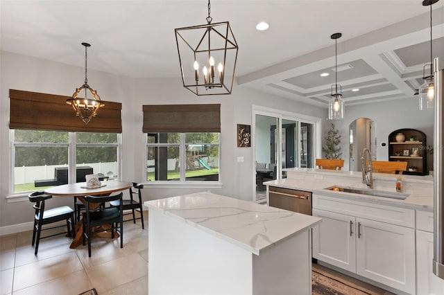 9512 Mid Summer Ln, Leesburg, FL 34788 - kitchen featuring a sink, dishwasher, arched walkways, hanging light fixtures, and light stone counters