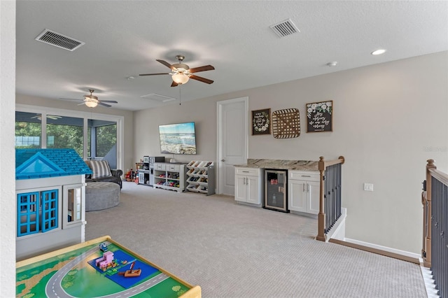 9512 Mid Summer Ln, Leesburg, FL 34788 - game room with a ceiling fan, wine cooler, light colored carpet, and baseboards