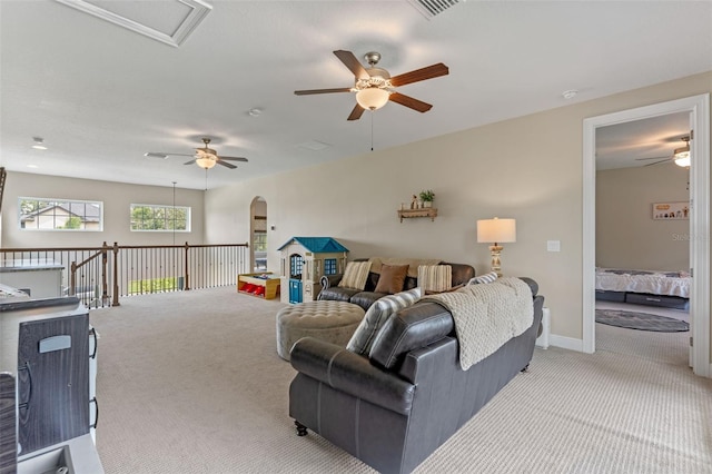 9512 Mid Summer Ln, Leesburg, FL 34788 - living room featuring carpet flooring, ceiling fan, arched walkways, and baseboards
