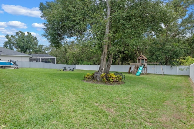 9512 Mid Summer Ln, Leesburg, FL 34788 - view of yard featuring a playground and view of wooded area