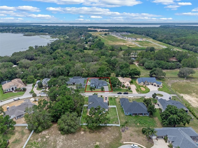 9512 Mid Summer Ln, Leesburg, FL 34788 - aerial perspective of suburban area with property boundaries highlighted, a large body of water, and a forest