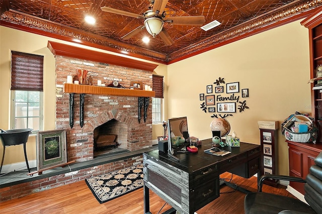 707 S Dixie Dr, Howey In The Hills, FL 34737 - office space with ornamental molding, an ornate ceiling, wood finished floors, ceiling fan, and a brick fireplace