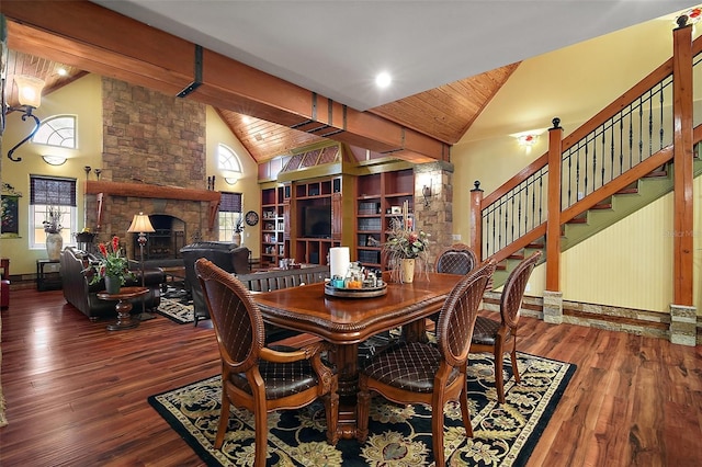 707 S Dixie Dr, Howey In The Hills, FL 34737 - dining space featuring high vaulted ceiling, a fireplace, hardwood / wood-style flooring, and plenty of natural light