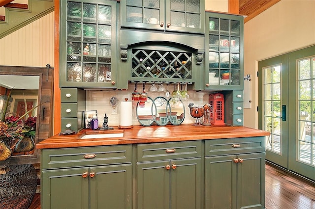 707 S Dixie Dr, Howey In The Hills, FL 34737 - indoor dry bar with french doors, backsplash, and dark wood-style floors