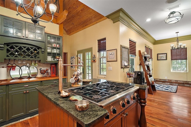 707 S Dixie Dr, Howey In The Hills, FL 34737 - kitchen featuring a chandelier, stainless steel gas stovetop, green cabinetry, a kitchen island, and light wood-style floors