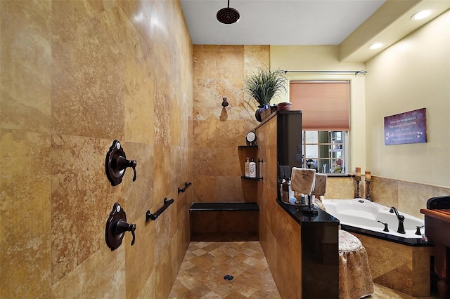 707 S Dixie Dr, Howey In The Hills, FL 34737 - bathroom featuring a bath, recessed lighting, tiled shower, and tile walls