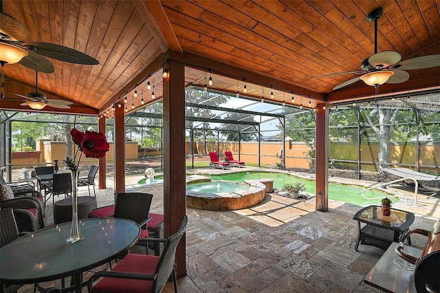 707 S Dixie Dr, Howey In The Hills, FL 34737 - sunroom / solarium with lofted ceiling, outdoor dining space, a swimming pool, and ceiling fan