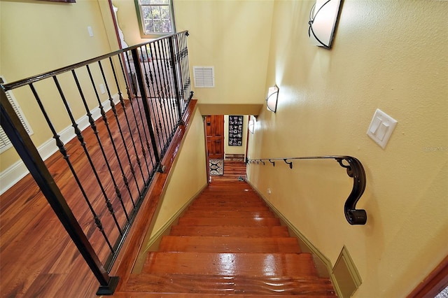707 S Dixie Dr, Howey In The Hills, FL 34737 - stairway with wood finished floors and baseboards
