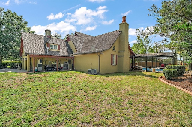 707 S Dixie Dr, Howey In The Hills, FL 34737 - back of property featuring a pool, a chimney, a yard, and stucco siding