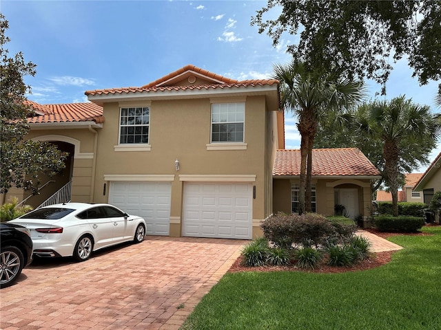5437 Compass Pt Unit 00, Oxford, FL 34484 - view of front of property with an attached garage, a tile roof, stucco siding, decorative driveway, and a front yard