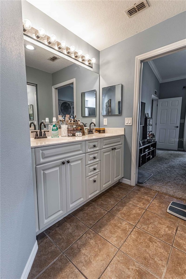 5437 Compass Pt Unit 00, Oxford, FL 34484 - full bath featuring double vanity, tile patterned flooring, ornamental molding, baseboards, and a textured ceiling