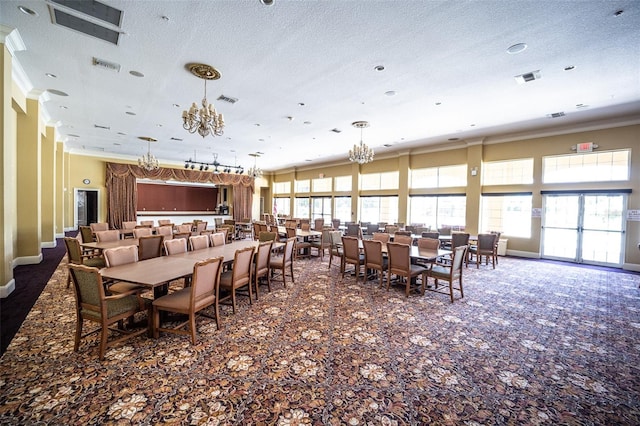 5437 Compass Pt Unit 00, Oxford, FL 34484 - dining area with crown molding, a chandelier, carpet flooring, and a textured ceiling