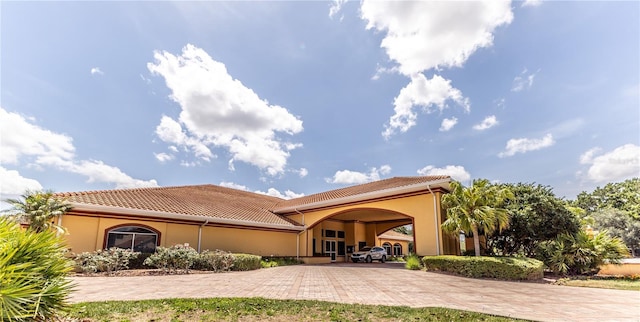 5437 Compass Pt Unit 00, Oxford, FL 34484 - rear view of property with decorative driveway, a tiled roof, and stucco siding