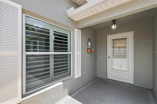 997 Oscar Ln, The Villages, FL 32162 - doorway to property featuring stucco siding