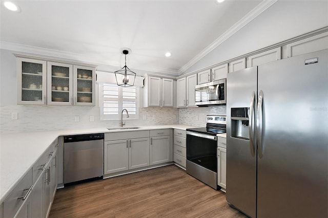 997 Oscar Ln, The Villages, FL 32162 - kitchen with stainless steel appliances, a sink, ornamental molding, gray cabinets, and backsplash