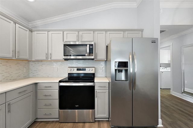 997 Oscar Ln, The Villages, FL 32162 - kitchen with stainless steel appliances, independent washer and dryer, lofted ceiling, ornamental molding, and gray cabinetry
