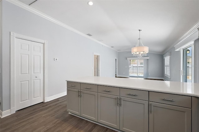 997 Oscar Ln, The Villages, FL 32162 - kitchen featuring gray cabinetry, a chandelier, light countertops, ornamental molding, and dark wood-type flooring