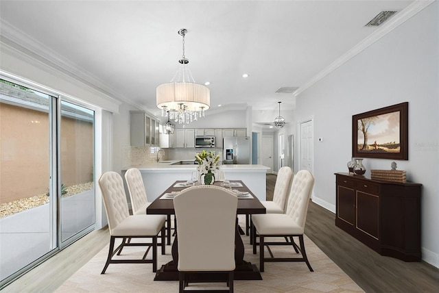 997 Oscar Ln, The Villages, FL 32162 - dining space featuring light wood finished floors, ornamental molding, a chandelier, recessed lighting, and baseboards
