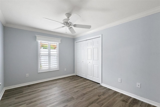 997 Oscar Ln, The Villages, FL 32162 - unfurnished bedroom with wood finished floors, crown molding, baseboards, a closet, and a ceiling fan