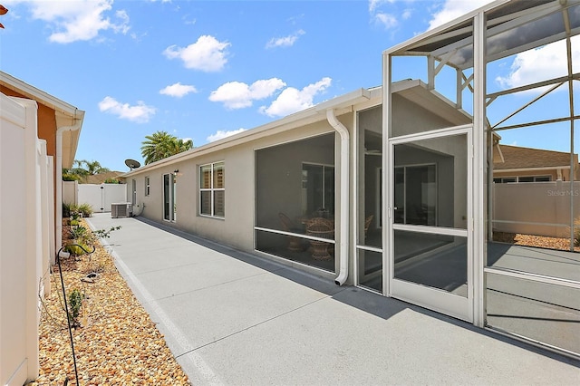 997 Oscar Ln, The Villages, FL 32162 - rear view of property featuring a patio, central AC unit, a lanai, and stucco siding