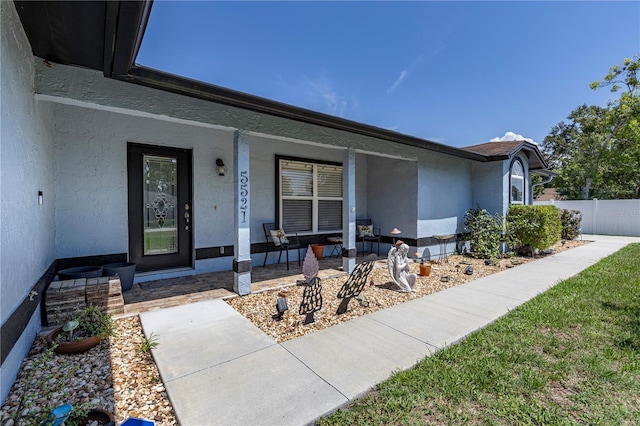 5521 Oak St, Mount Dora, FL 32757 - view of exterior entry featuring covered porch and stucco siding
