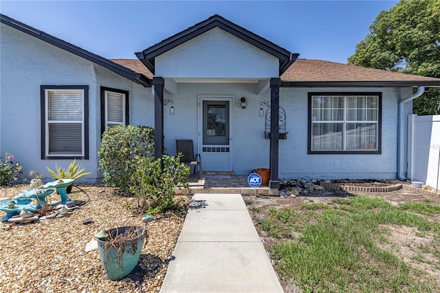 5521 Oak St, Mount Dora, FL 32757 - view of front facade featuring roof with shingles and stucco siding