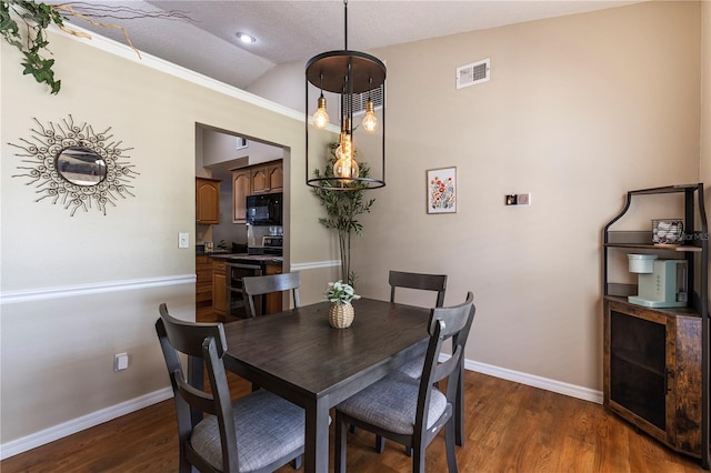 5521 Oak St, Mount Dora, FL 32757 - dining room with lofted ceiling, baseboards, and wood finished floors
