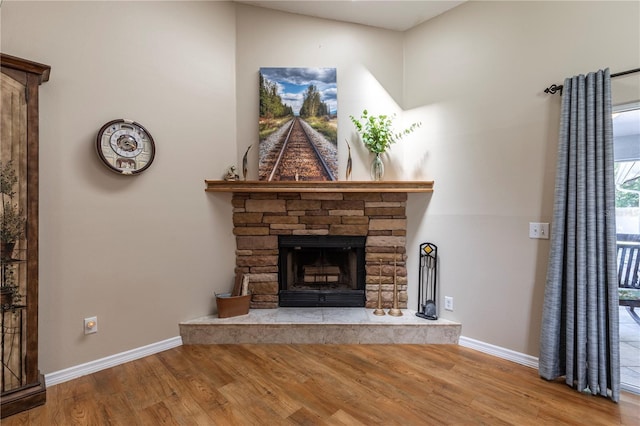 5521 Oak St, Mount Dora, FL 32757 - living room featuring wood finished floors, baseboards, and a stone fireplace