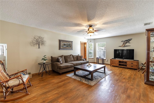5521 Oak St, Mount Dora, FL 32757 - living room with wood finished floors, a ceiling fan, a textured ceiling, and baseboards