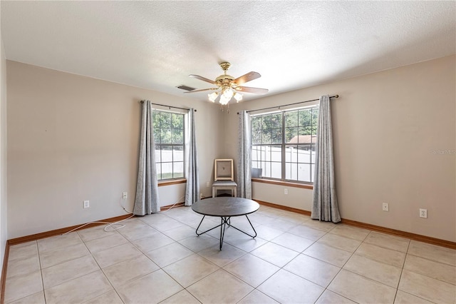 5521 Oak St, Mount Dora, FL 32757 - unfurnished room featuring a textured ceiling, ceiling fan, baseboards, and light tile patterned floors