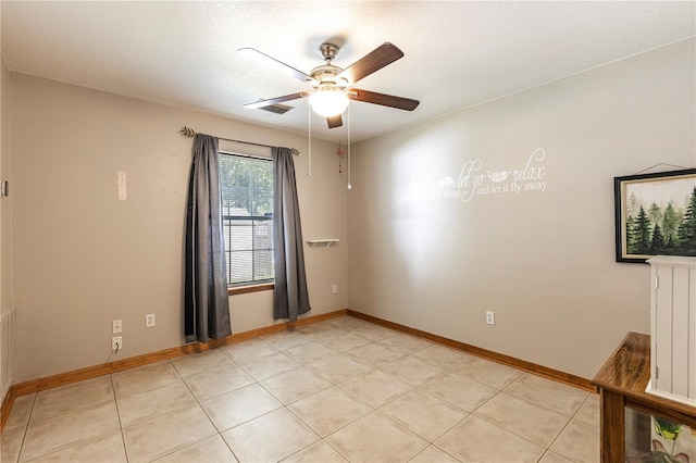 5521 Oak St, Mount Dora, FL 32757 - unfurnished room with ceiling fan, baseboards, a textured ceiling, and light tile patterned floors