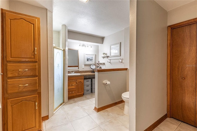 5521 Oak St, Mount Dora, FL 32757 - full bathroom featuring vanity, a stall shower, tile patterned floors, toilet, and baseboards