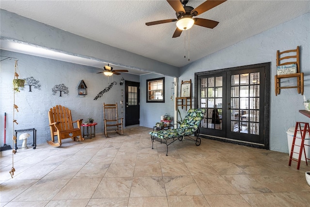 5521 Oak St, Mount Dora, FL 32757 - sitting room featuring a ceiling fan, vaulted ceiling, a textured wall, a textured ceiling, and french doors
