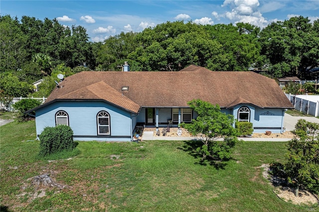 5521 Oak St, Mount Dora, FL 32757 - view of front of house featuring stucco siding, a front lawn, and a shingled roof