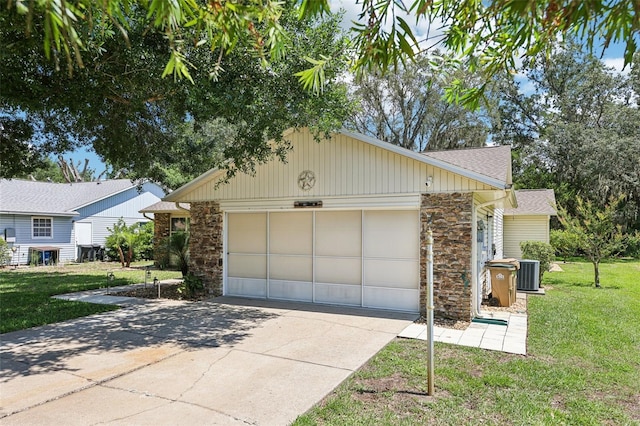 1011 Dundee Cir, Leesburg, FL 34788 - view of side of home with stone siding, cooling unit, driveway, a garage, and a yard