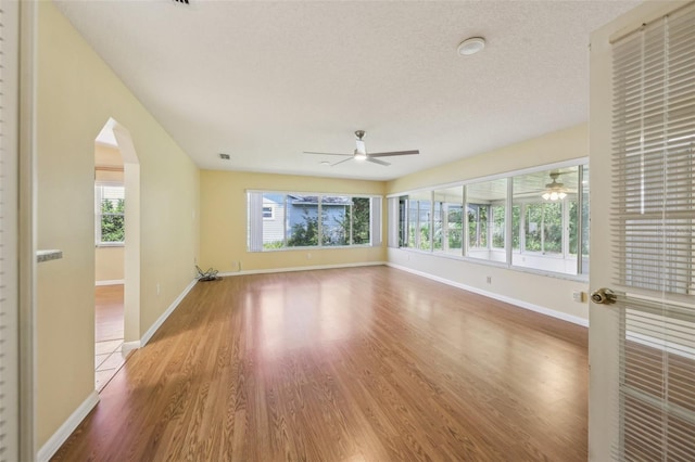1011 Dundee Cir, Leesburg, FL 34788 - spare room with ceiling fan, healthy amount of natural light, wood finished floors, and baseboards