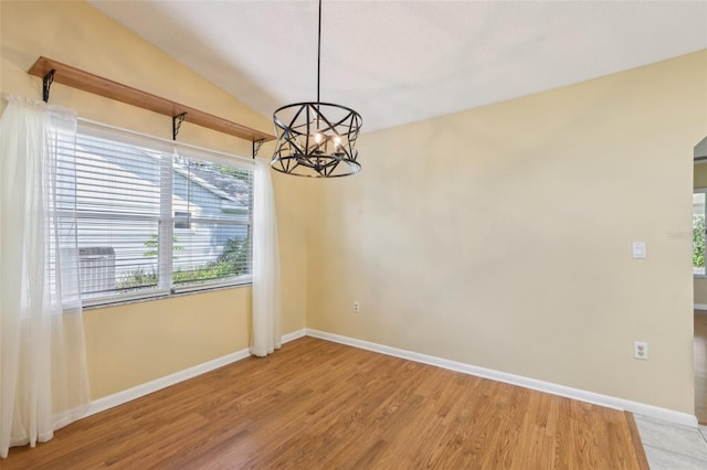 1011 Dundee Cir, Leesburg, FL 34788 - empty room featuring a chandelier, baseboards, light wood finished floors, and lofted ceiling