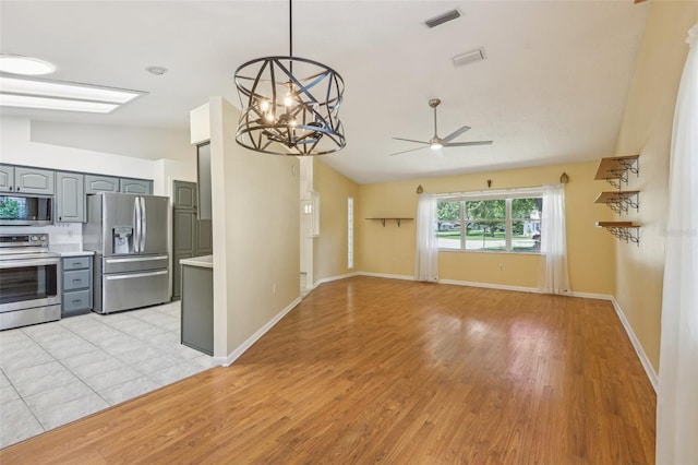 1011 Dundee Cir, Leesburg, FL 34788 - kitchen featuring appliances with stainless steel finishes, gray cabinets, light countertops, ceiling fan, and light wood finished floors