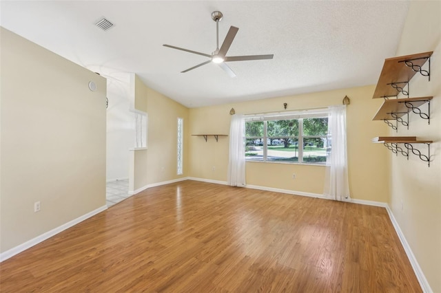 1011 Dundee Cir, Leesburg, FL 34788 - spare room with a ceiling fan, wood finished floors, lofted ceiling, and baseboards