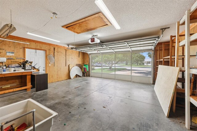 1011 Dundee Cir, Leesburg, FL 34788 - garage featuring a garage door opener and wooden walls