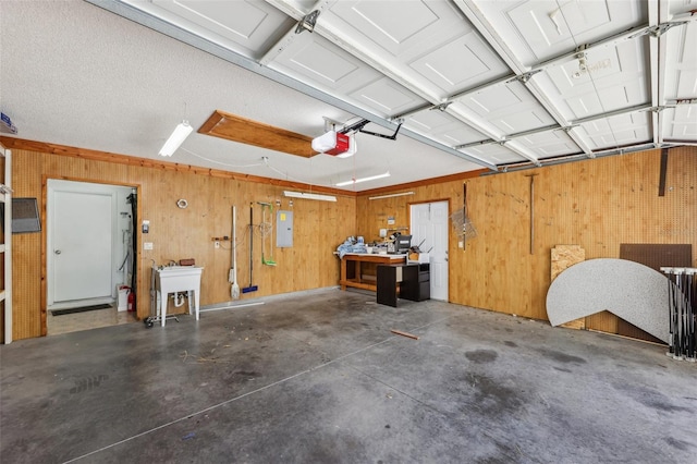1011 Dundee Cir, Leesburg, FL 34788 - garage with a workshop area, a garage door opener, electric panel, wood walls, and a sink