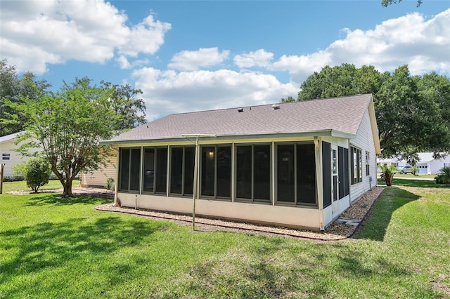 1011 Dundee Cir, Leesburg, FL 34788 - back of house featuring a sunroom, a yard, and roof with shingles